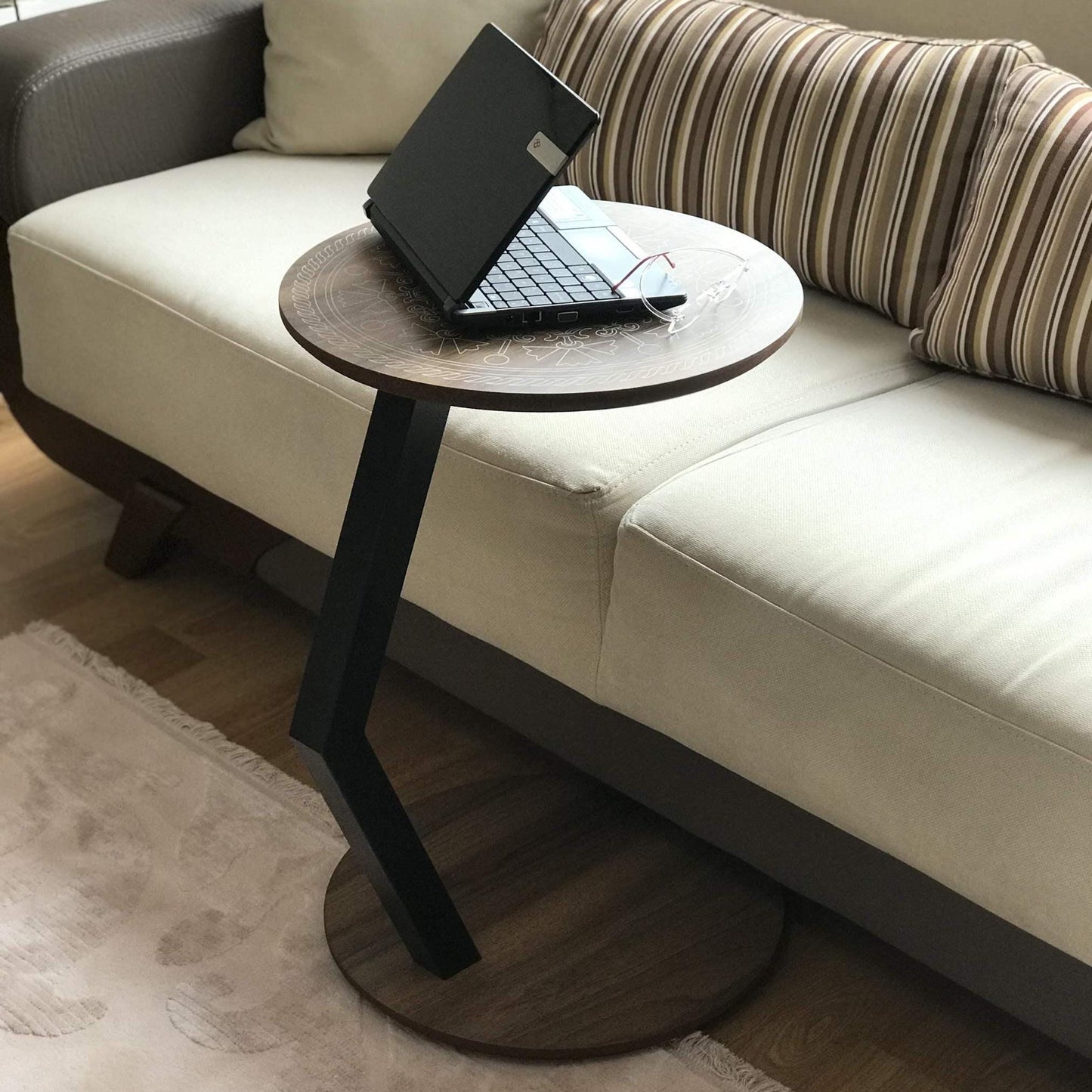 A modern C-shaped side table designed to stay right by their side