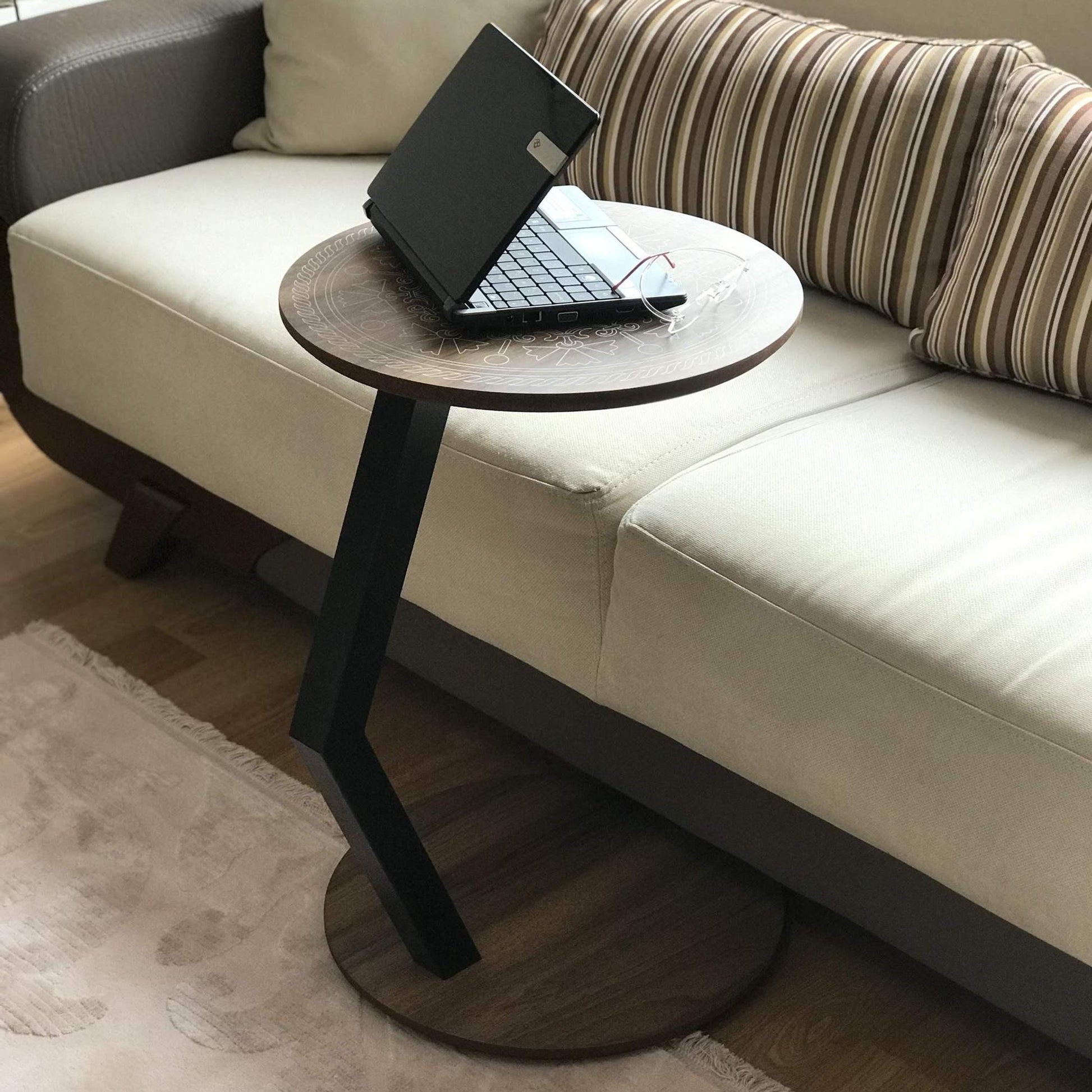 A modern C-shaped side table designed to stay right by their side