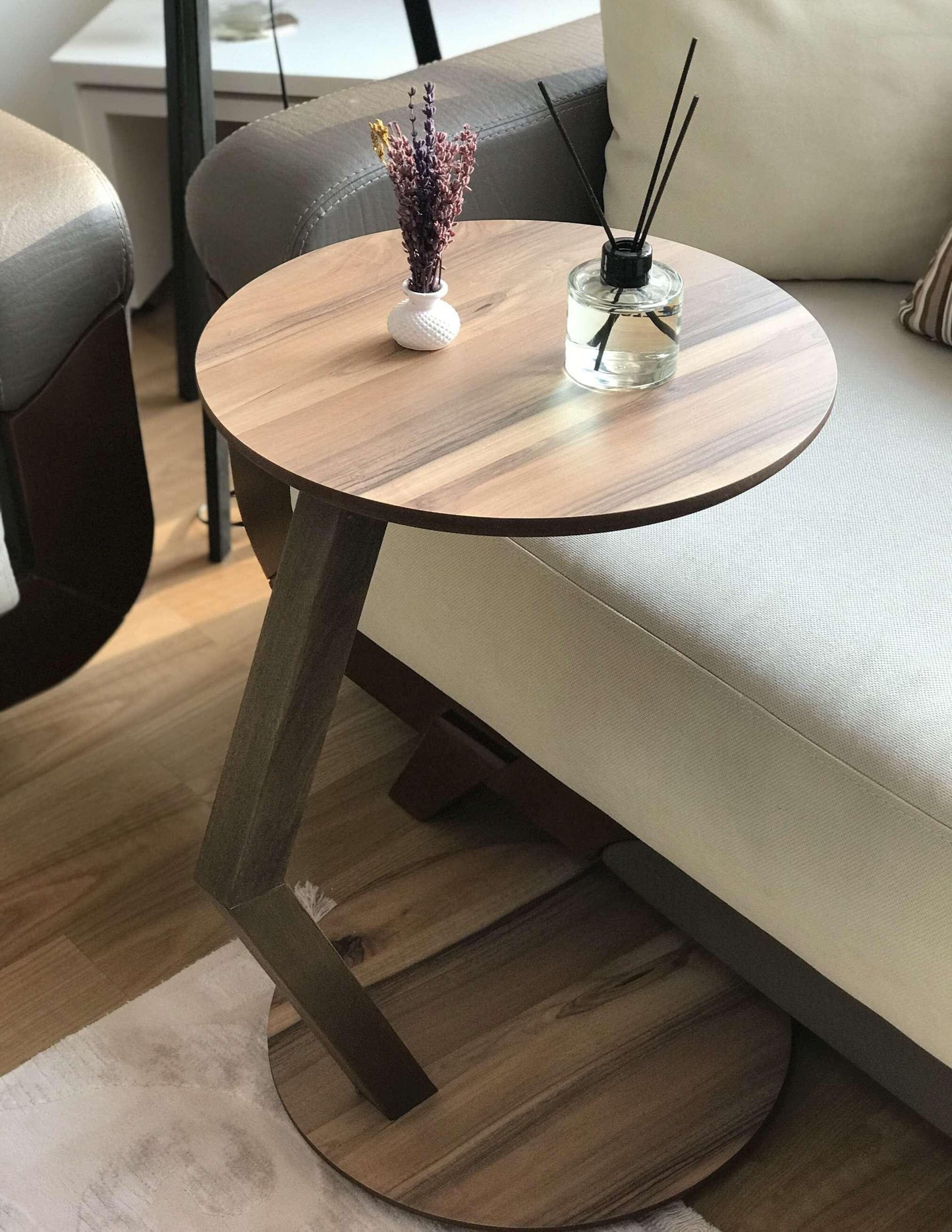 A modern C-shaped side table designed to stay right by their side