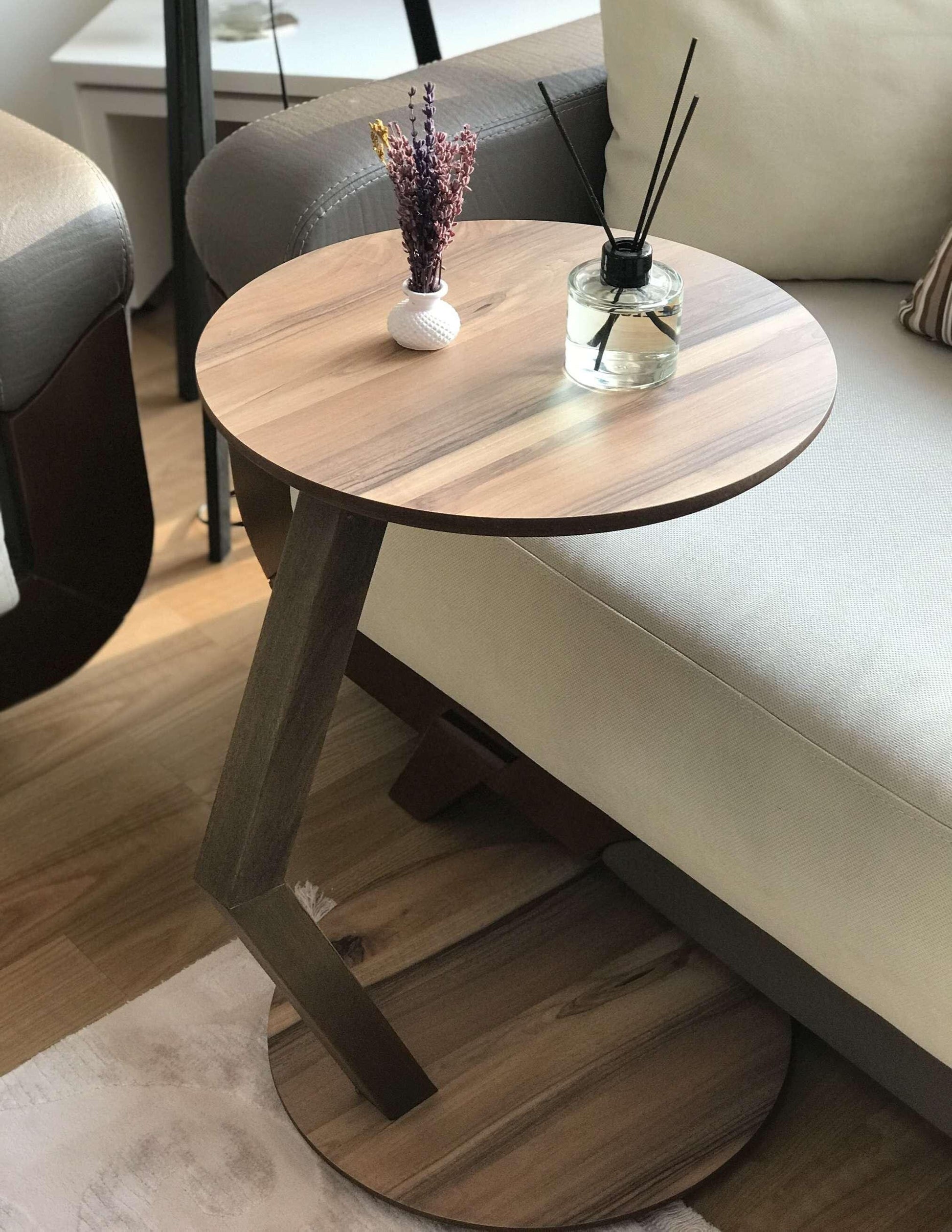 A modern C-shaped side table designed to stay right by their side